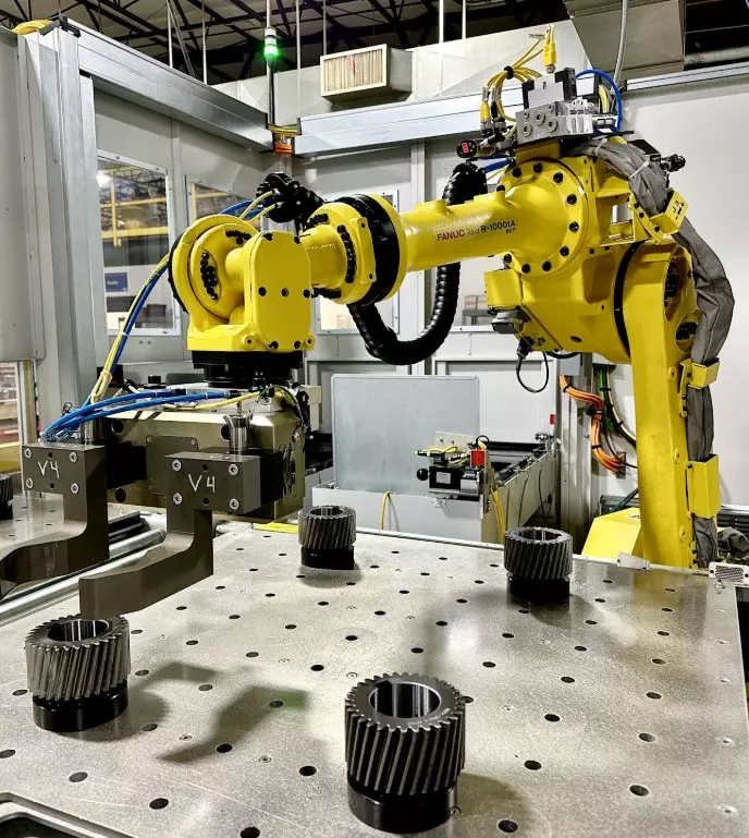 Industrial robotic arm handling precision gears in an automated manufacturing environment for servo gearboxes  